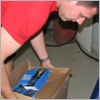 A NorthStar Moving crew member arranging the programs