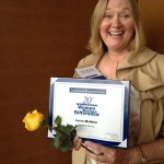 NorthStar Moving Corporation's Owner and Co-Founder Laura Mcholm at the reception holding the award!